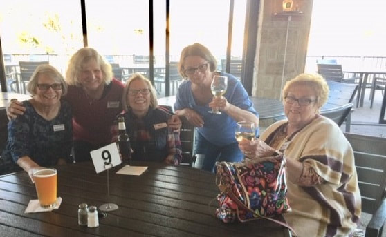 5 women around a table